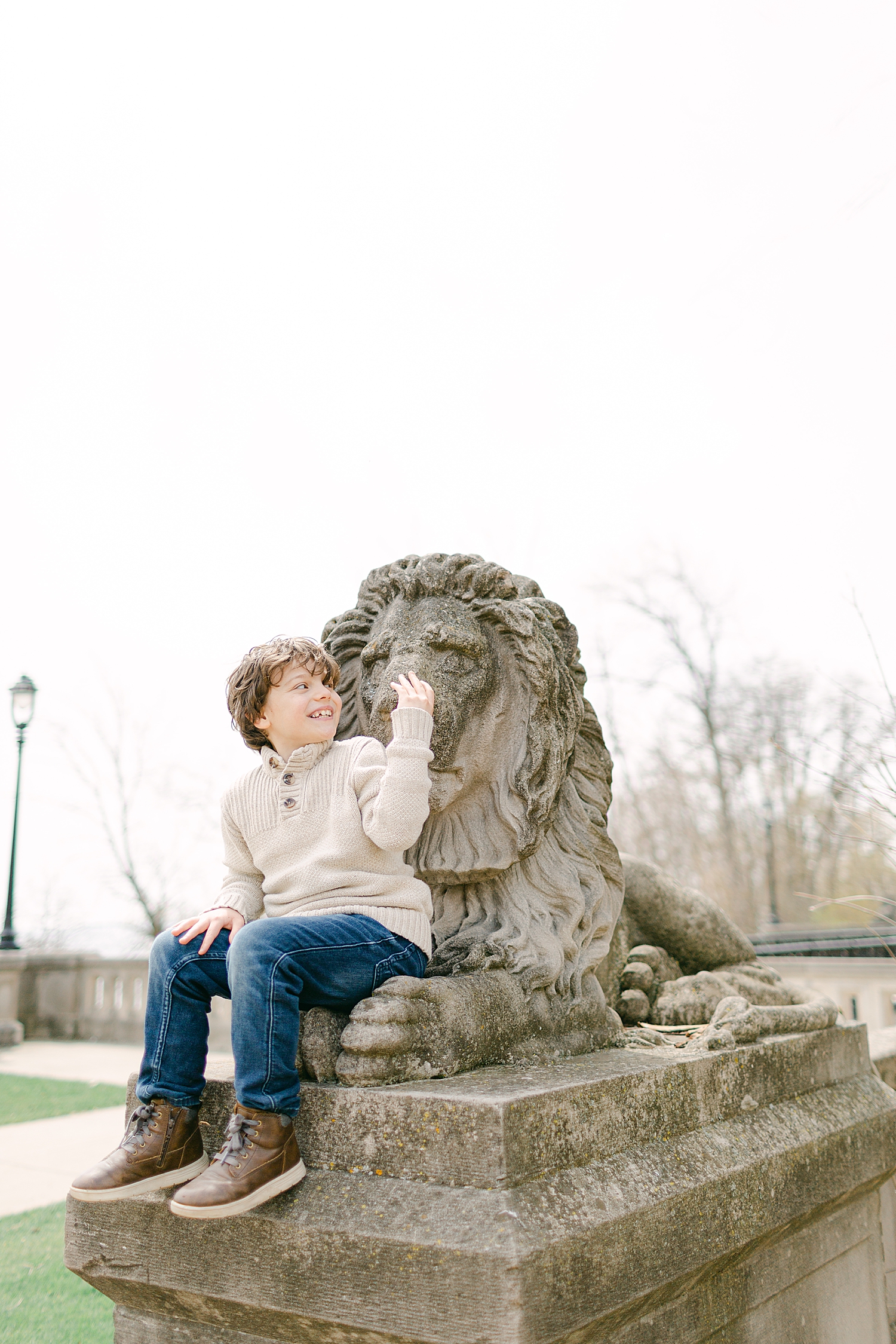 Young boy on Lion Head bridge in Lake Park in Milwaukee at family photos at North Point Lighthouse in Lake Park, Milwaukee.