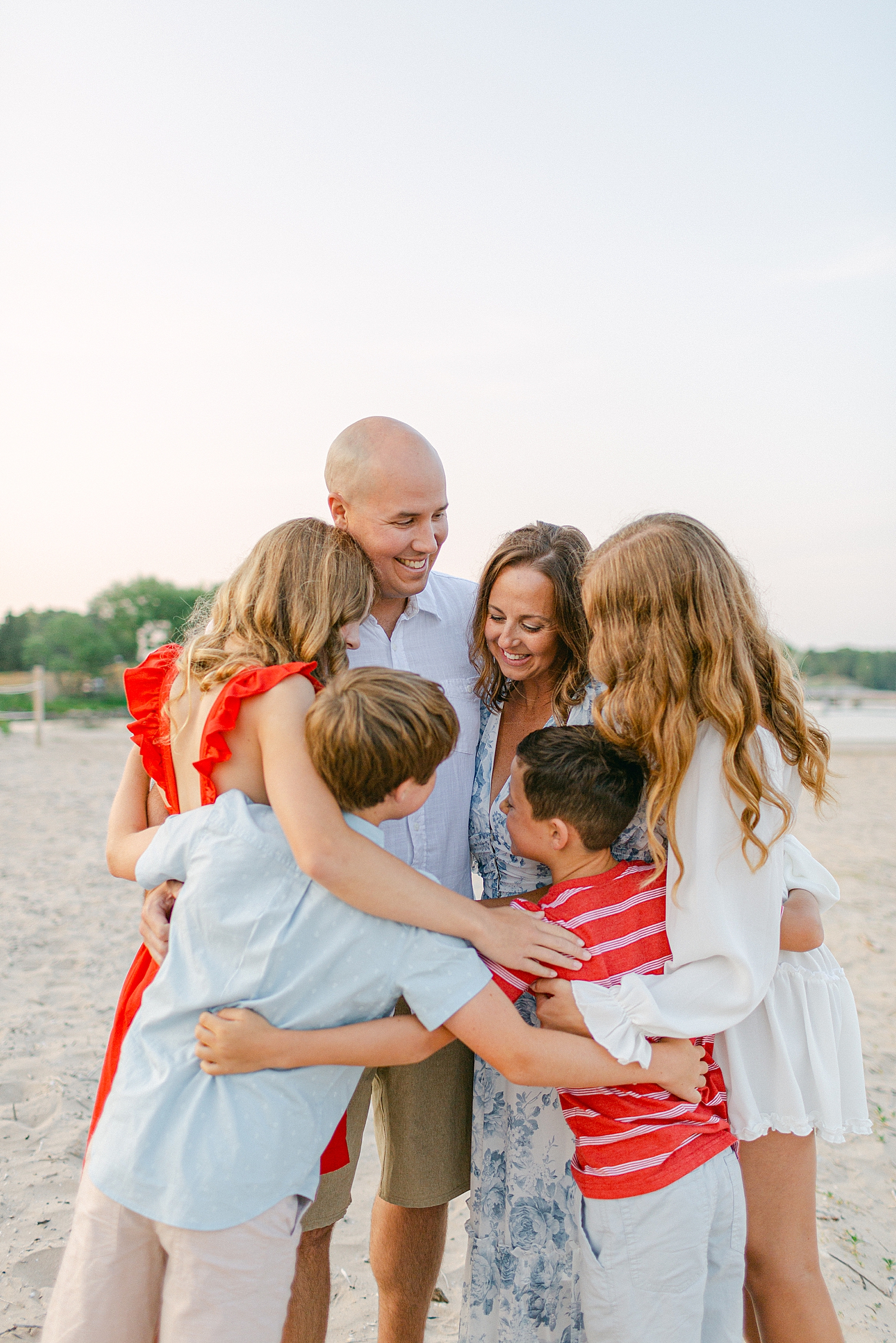 family hug on the beach at a Sturgeon Bay Canal Light Family Session