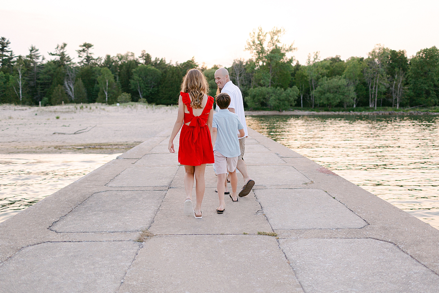 A family walking on the pier at their Sturgeon Bay Canal Light Family Session