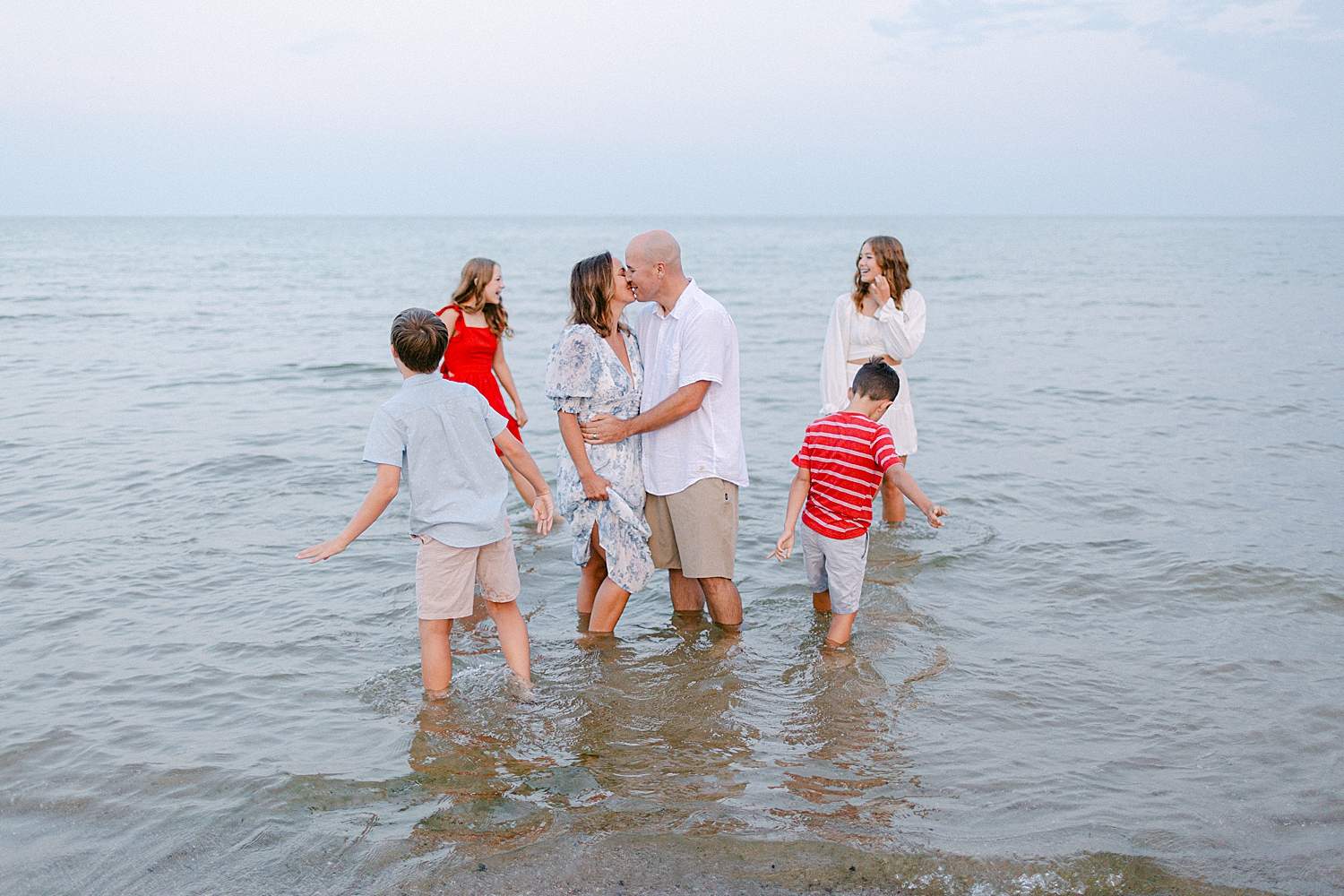 Family playing in the water at the beach at their Sturgeon Bay Canal Light Family Session