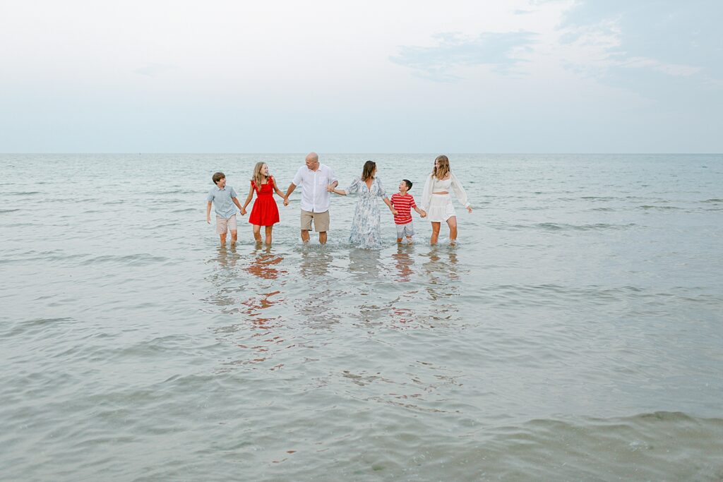 Family playing in the water at the beach at their Sturgeon Bay Canal Light Family Session