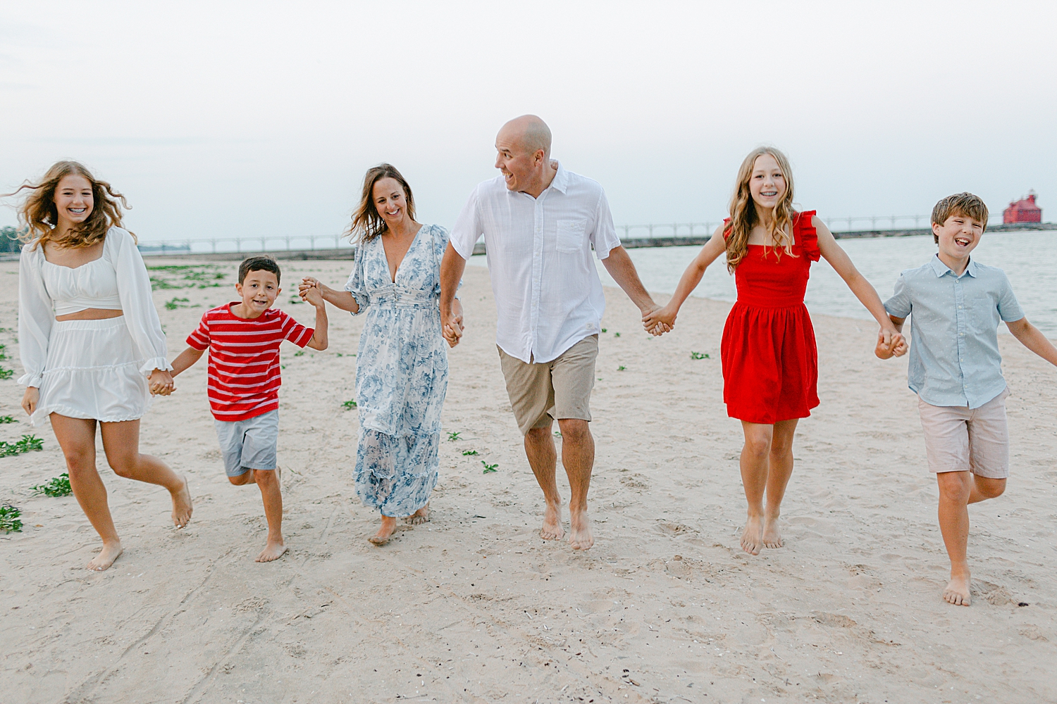 Family playing on the beach at their Sturgeon Bay Canal Light Family Session
