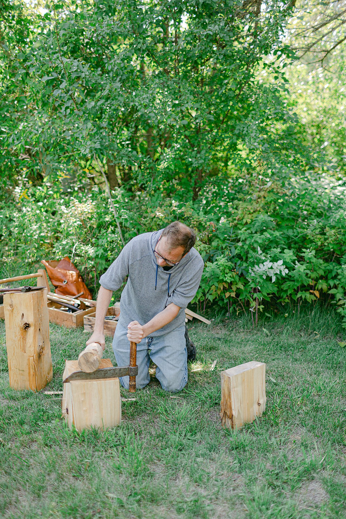 man splitting wood for shingle at the Hanson House at Big Creek