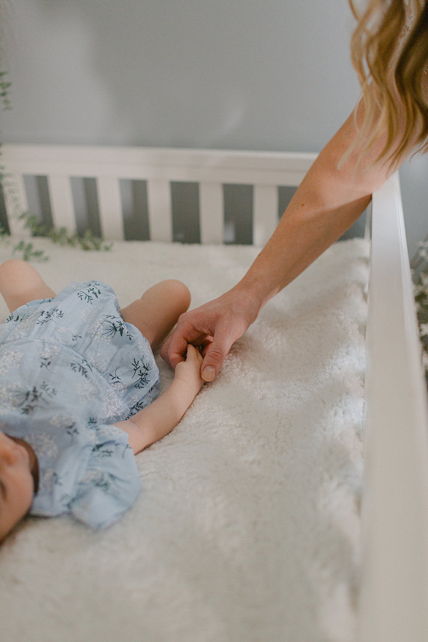 Mom & Baby holding hands at a Newborn Session in Green Bay